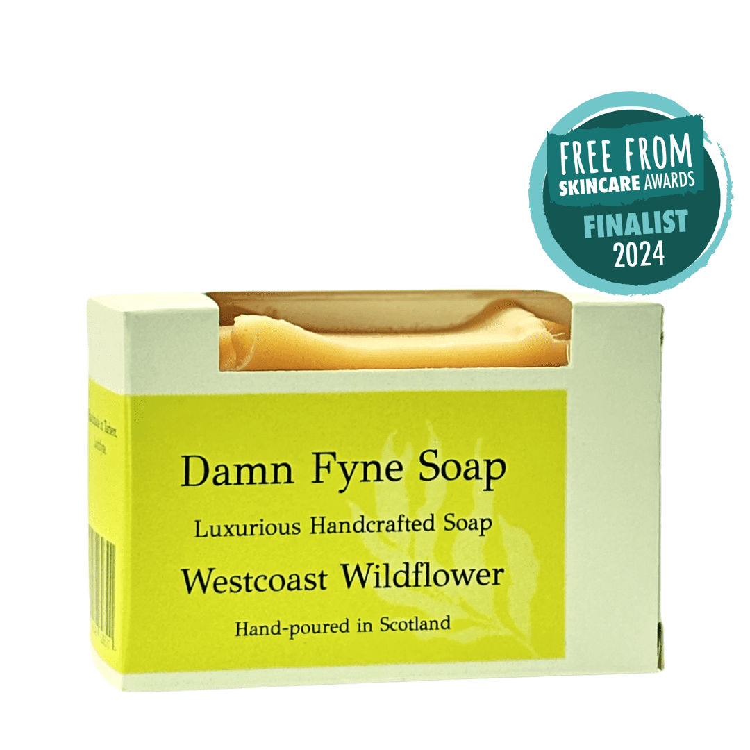 Westcoast Wildflower handmade soap bar in biodegradable kraft packaging with a soft pink label. Label reads “Damn Fyne Soap – Luxurious Handcrafted Soap – Westcoast Wildflower – Hand-poured in Scotland.” Pale-toned soap visible above the box, photographed on a neutral background.