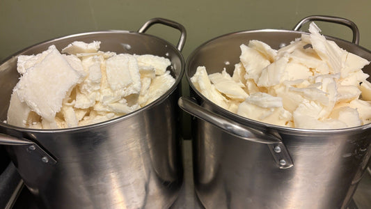 Plant oils and butters weighed in stainless steel pans for handmade soap making in our Tarbert workshop.