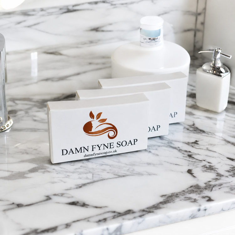 a marble bathroom with damn fyne soap guest soaps