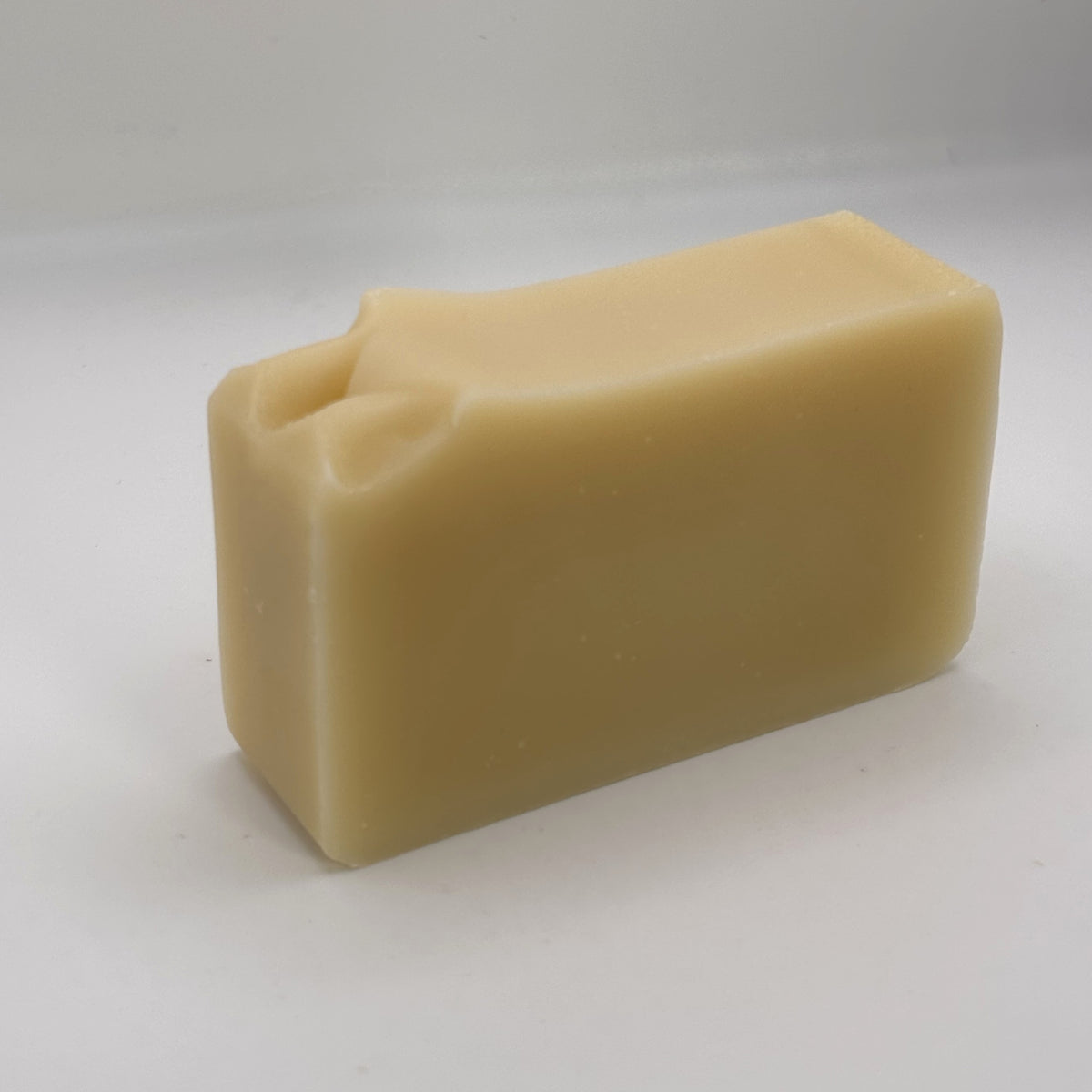 Unwrapped Argyll Citrus Mist handmade soap bar showing its natural colour and hand-finished top.