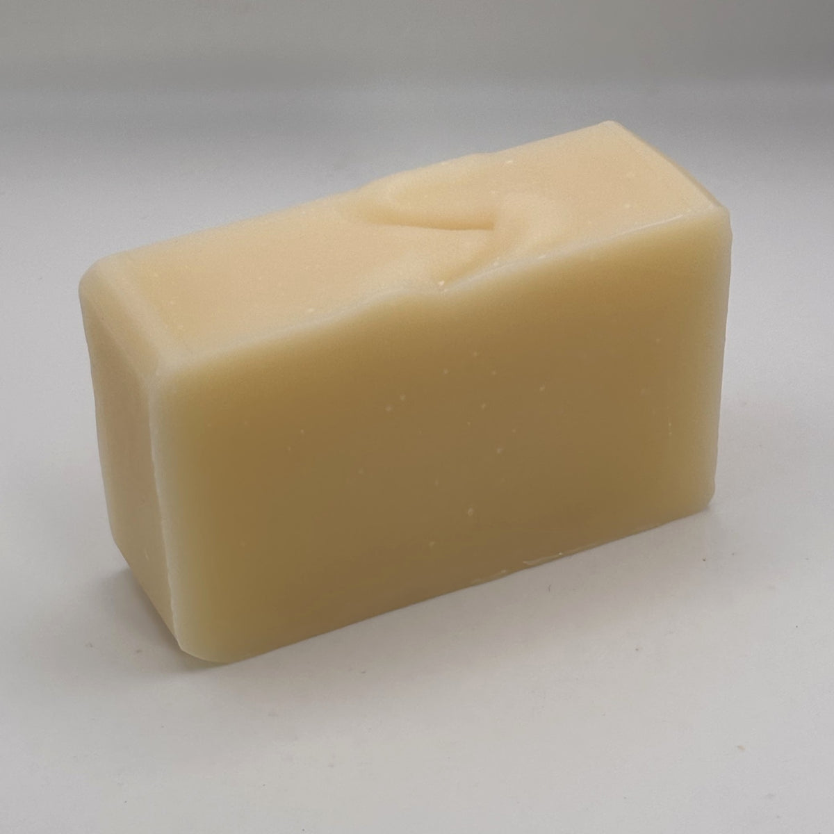 Unwrapped Glen Rosa handmade soap bar with a naturally creamy colour and hand-finished top.