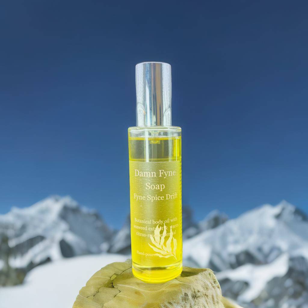 Fyne Spice Drift Body Oil bottle with warm citrus-spice essential oils and seaweed extract. Luxury body oil.