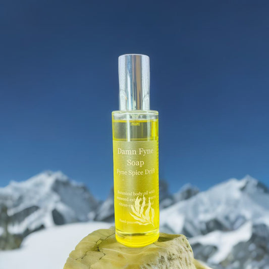 Fyne Spice Drift Body Oil bottle with warm citrus-spice essential oils and seaweed extract. Luxury body oil.