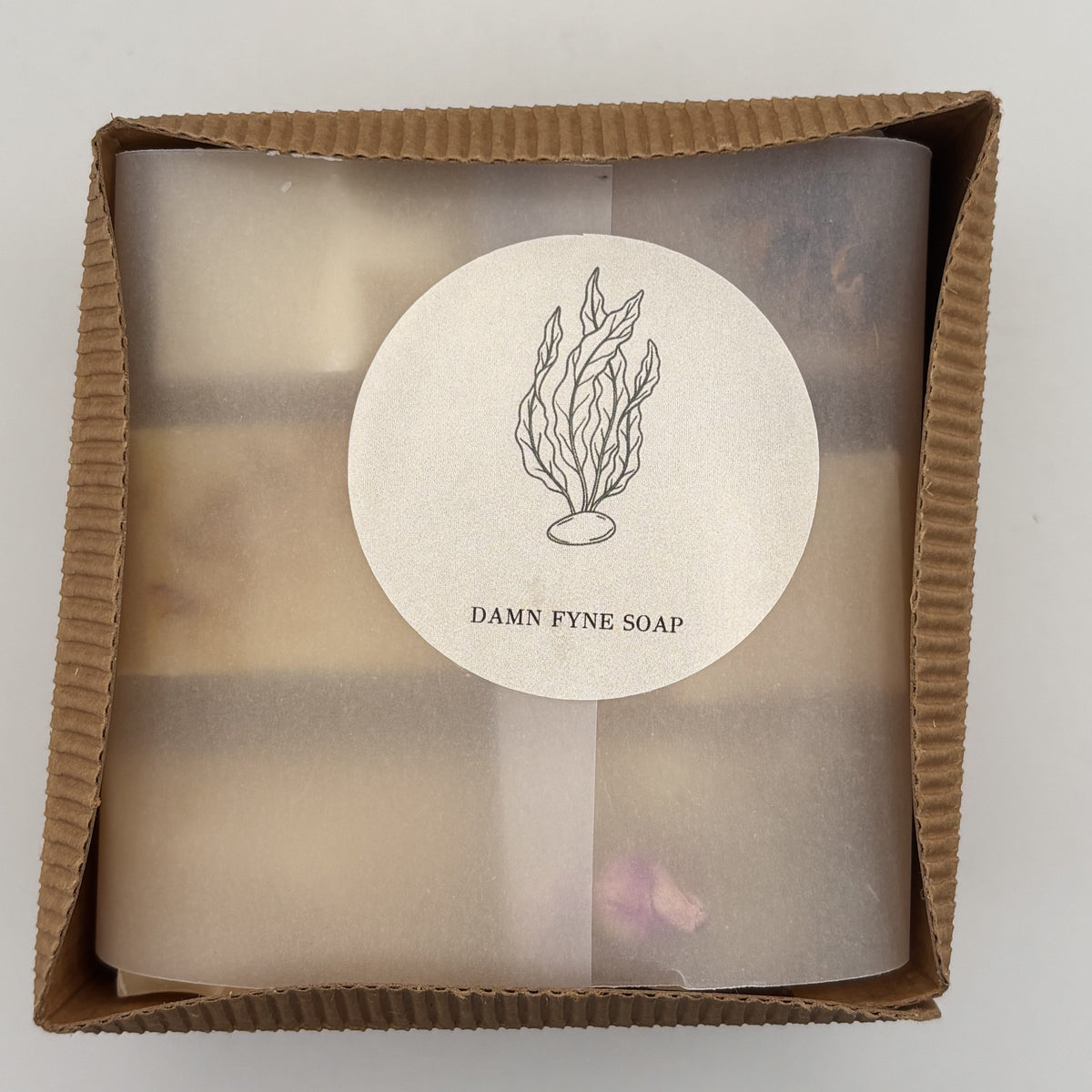 Six soap gift box wrapped in translucent vellum with Damn Fyne Soap seaweed seal