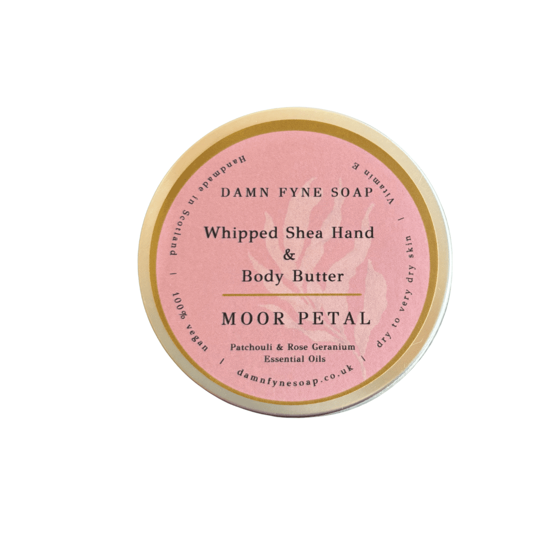 Pink-labeled container of Damn Fyne Soap’s Moor Petal Whipped Shea Hand & Body Butter, scented with patchouli and rose geranium essential oils. Handmade in Scotland.
