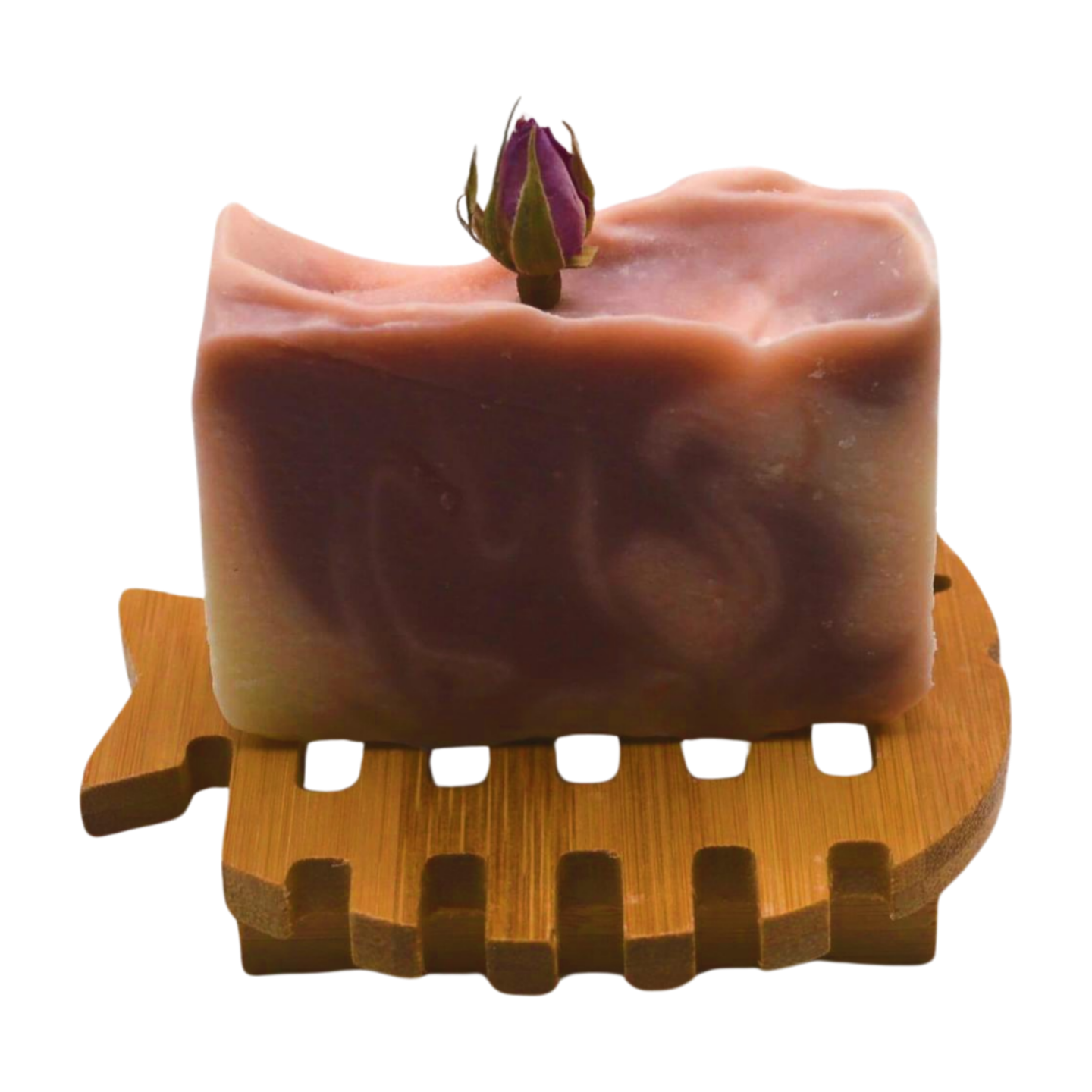 Natural fish-shaped Hemu wood soap dish with drainage slots for handmade soap. With a soap bar sitting on it.