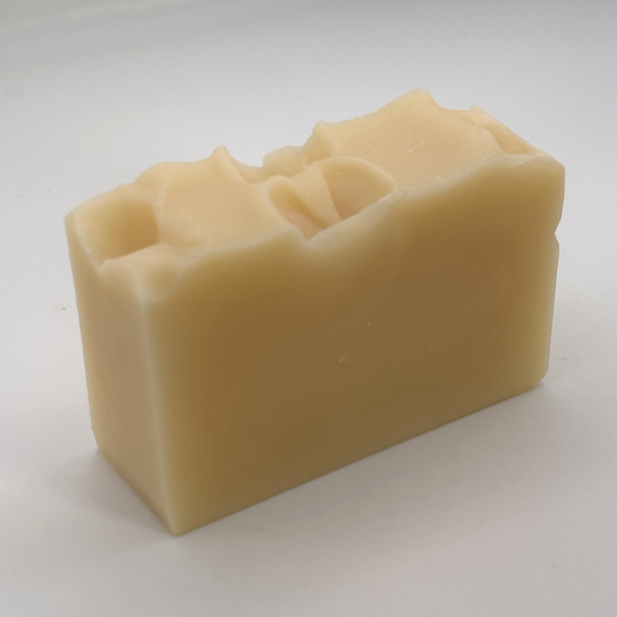 Unwrapped Fyne Spice Drift handmade soap bar showing its natural colour and hand-finished textured top.