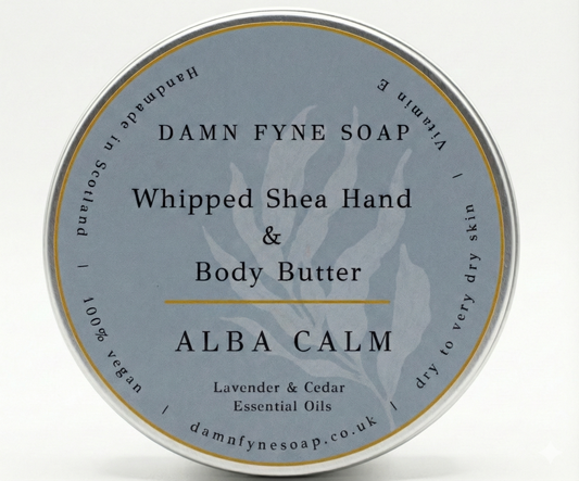 Round container of Damn Fyne Soap’s Alba Calm Whipped Shea Hand & Body Butter, featuring a soft grey label with gold border. Scented with lavender and cedar essential oils, designed for calming and moisturising skin.