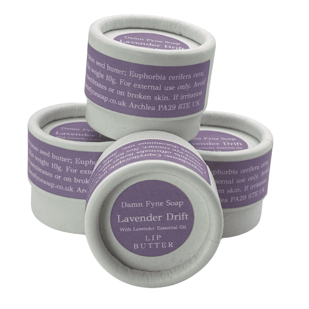 Stack of Lavender Drift Lip Butter pots showing biodegradable packaging and handmade Scottish lip balm.oil.