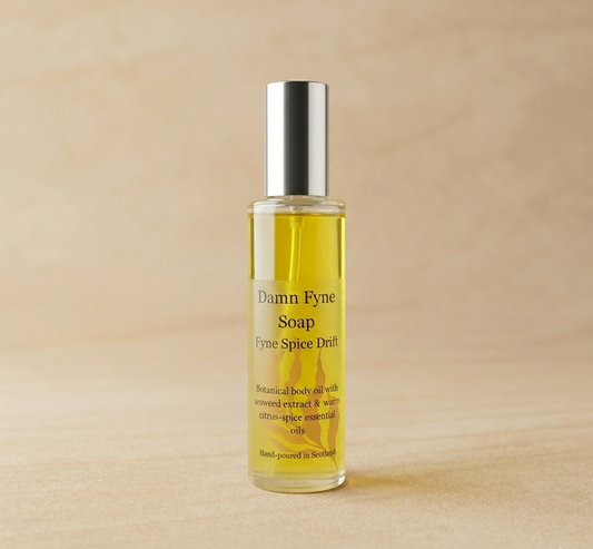 Fyne Spice Drift Body Oil bottle with warm citrus-spice essential oils and seaweed extract. Luxury body oil in a glass bottle.