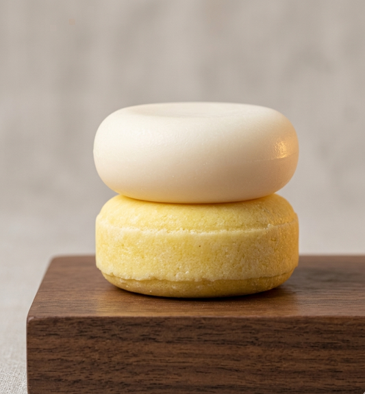 stacked shampoo and conditioner bar. cream conditioner bar, yellow shampoo bar.