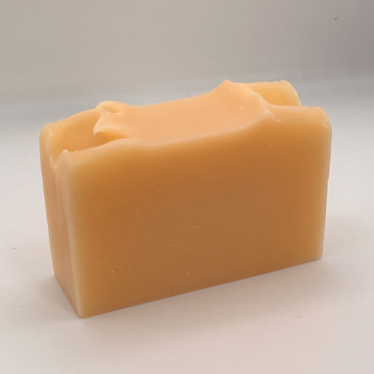 Unwrapped Westcoast Wildflower handmade soap bar showing its natural colour and hand-finished top.