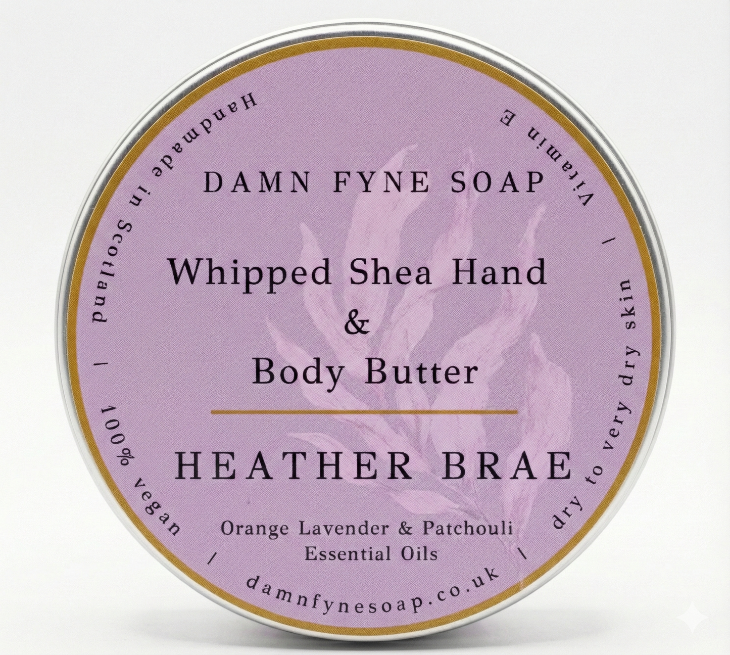 Lavender and gold-labeled container of Damn Fyne Soap’s Heather Brae Whipped Shea Hand & Body Butter, scented with orange, lavender, and patchouli essential oils. Handmade in Scotland.